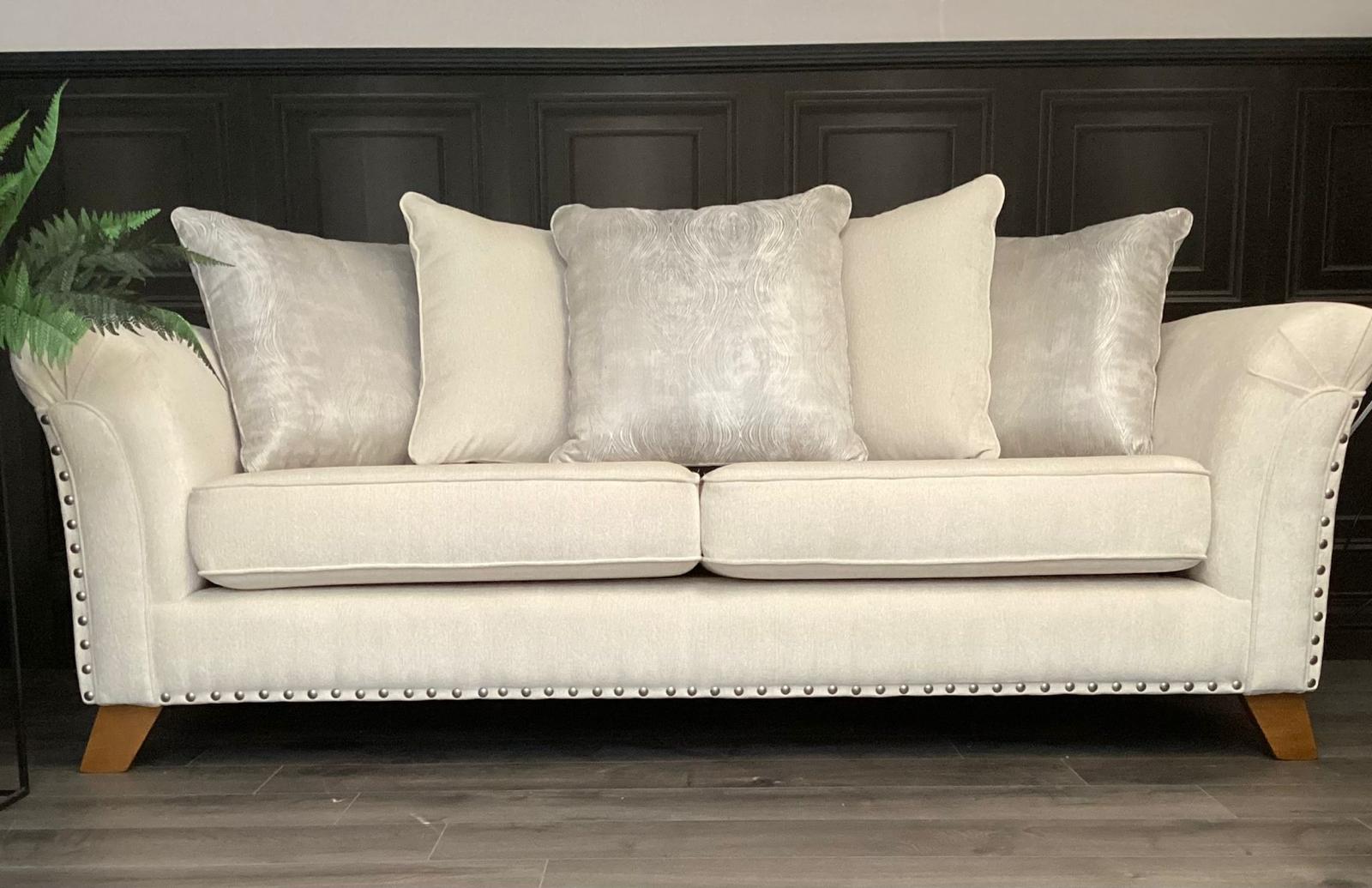 Cream studded two-seater against dark panelling