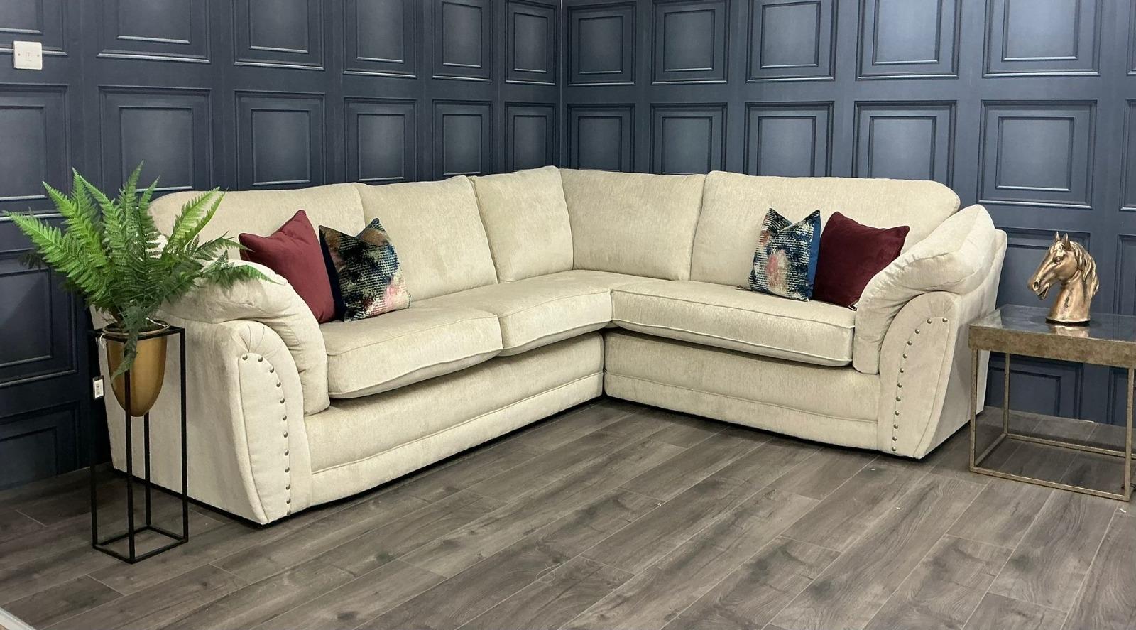 Cream corner sofa against navy panelling